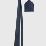 This plain red textured polyester tie from Taylor & Wright is perfect for the office and formal occasions alike. Dimensions: Blade Width: 7.5cm. Length: 148cm.