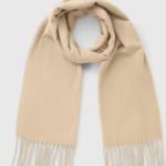 Elevate your cold-weather style with this Stone Fringe Trim Scarf. Crafted in a soft, cozy fabric and finished with delicate fringe detailing, it’s the perfect blend of comfort and sophistication. The stone tone makes it easy to pair with any outfit, while the timeless design ensures it will be a wardrobe staple for seasons to come. Ideal for layering on chilly days or adding a stylish touch to your everyday look.